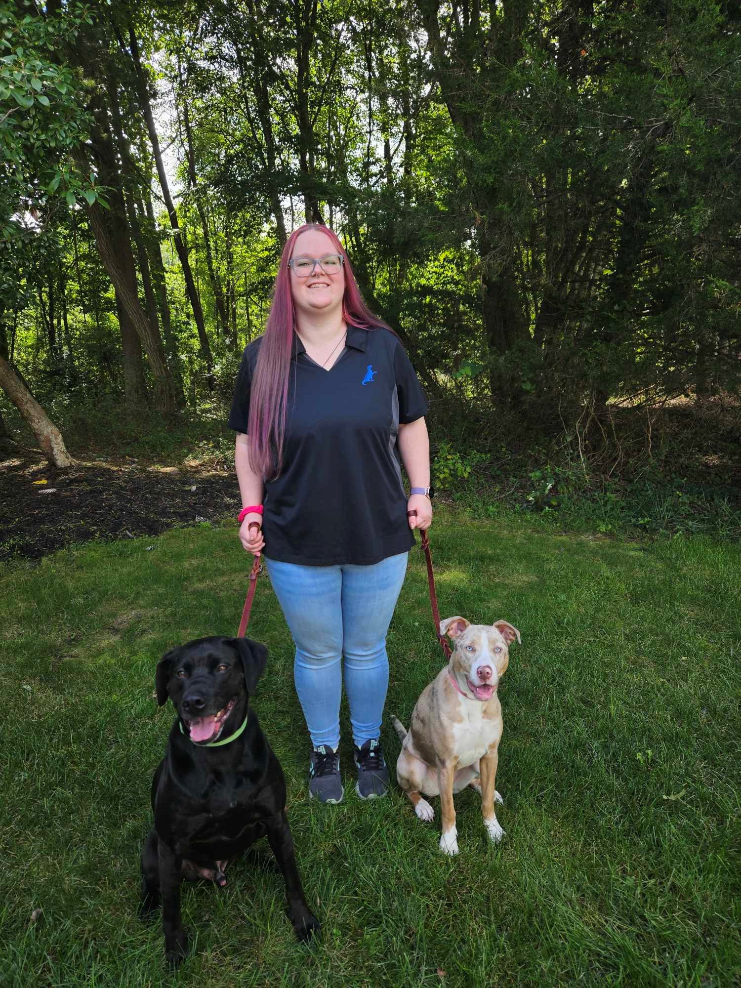 trainer with two dogs one on the right and one on the left